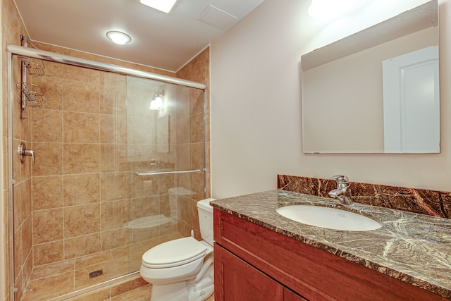 bathroom with a shower with door, toilet, and vanity