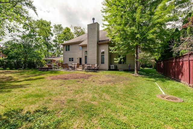 back of property featuring a deck and a yard