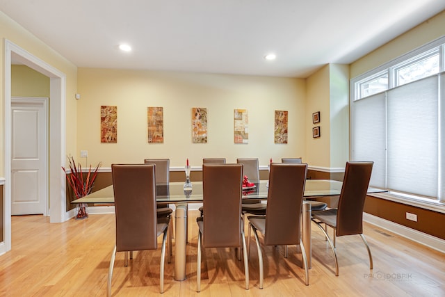 dining space with light hardwood / wood-style floors