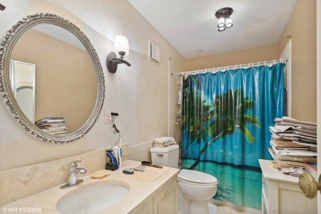 bathroom featuring toilet and vanity