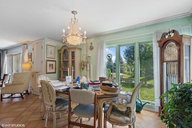 dining area with light parquet floors, ornamental molding, a wealth of natural light, and a chandelier