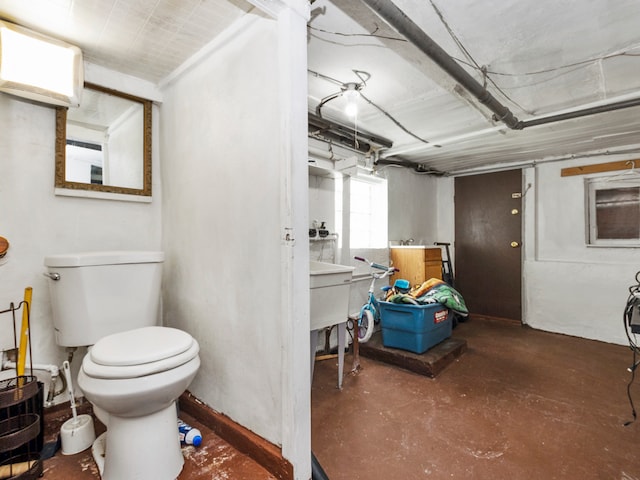 bathroom featuring toilet and concrete floors