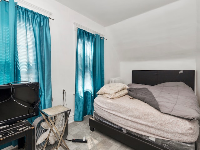 tiled bedroom featuring multiple windows