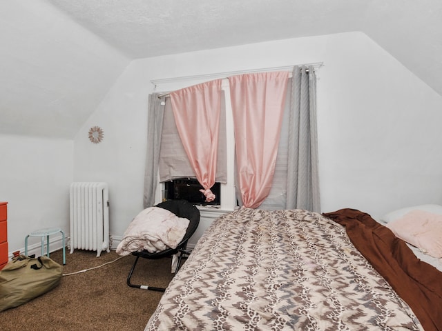 carpeted bedroom featuring lofted ceiling, a textured ceiling, and radiator heating unit