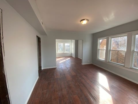 empty room with dark hardwood / wood-style floors