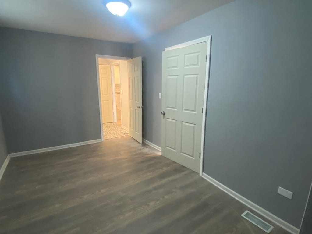 interior space with dark hardwood / wood-style floors and a closet