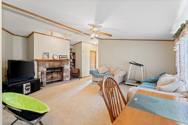 living room with light carpet, ceiling fan, ornamental molding, a stone fireplace, and lofted ceiling