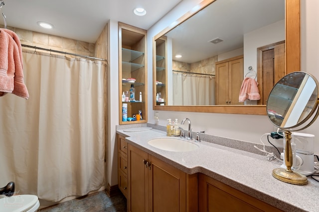 bathroom with toilet, tile flooring, and vanity