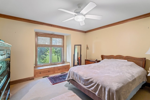 carpeted bedroom with ceiling fan and crown molding