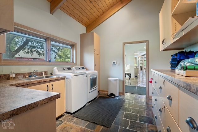 laundry area featuring dark tile floors, separate washer and dryer, sink, and wood ceiling