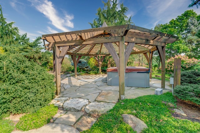 view of terrace featuring a pergola and a hot tub