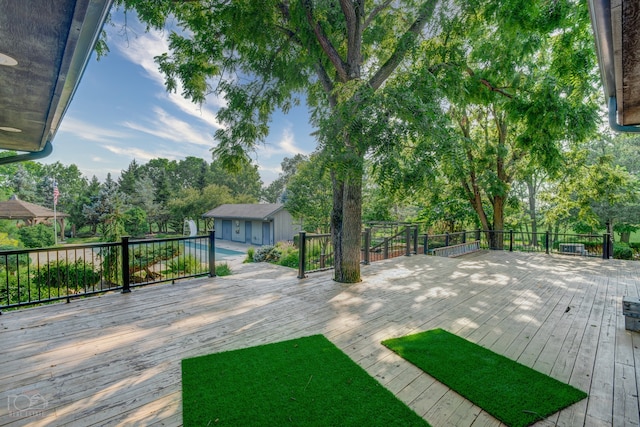 view of yard featuring a wooden deck and an outdoor structure