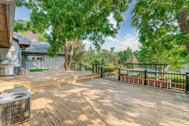 wooden deck featuring a grill and central air condition unit