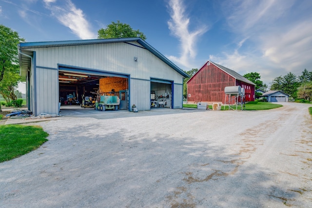 view of side of property with an outdoor structure and a garage