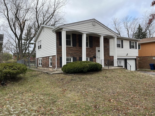 bi-level home featuring a front lawn and a garage