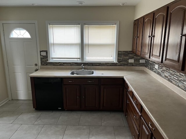 kitchen with sink, dishwasher, light tile patterned floors, backsplash, and dark brown cabinetry