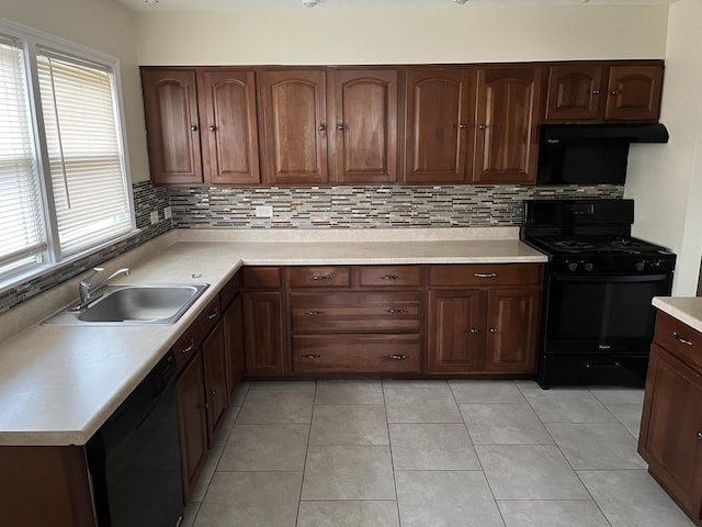 kitchen featuring sink, light tile patterned floors, backsplash, and black appliances