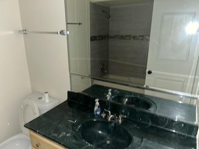 full bathroom with toilet, tiled shower / bath combo, and vanity