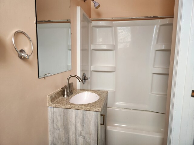 bathroom with vanity and washtub / shower combination