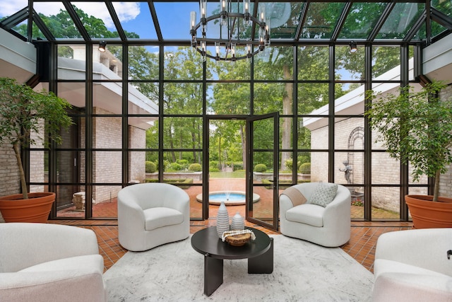 sunroom / solarium featuring a chandelier