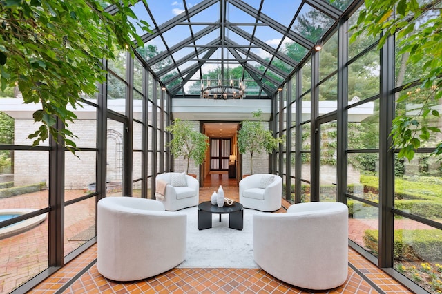 sunroom featuring vaulted ceiling and a chandelier