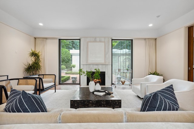 living room with a fireplace with flush hearth and recessed lighting