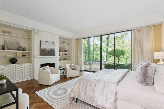 bedroom with access to exterior and dark parquet flooring