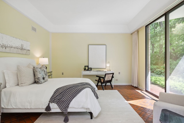 bedroom with access to outside, visible vents, and baseboards