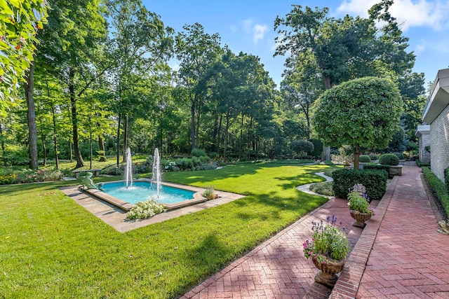 view of swimming pool featuring a lawn