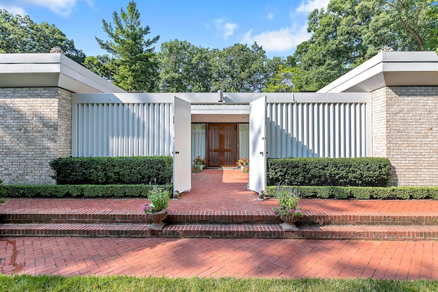 property entrance featuring stucco siding and brick siding