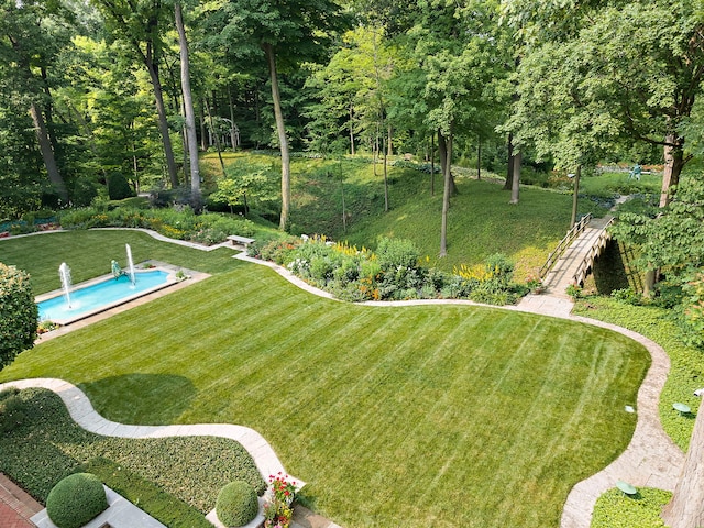 view of yard featuring stairs and an outdoor pool