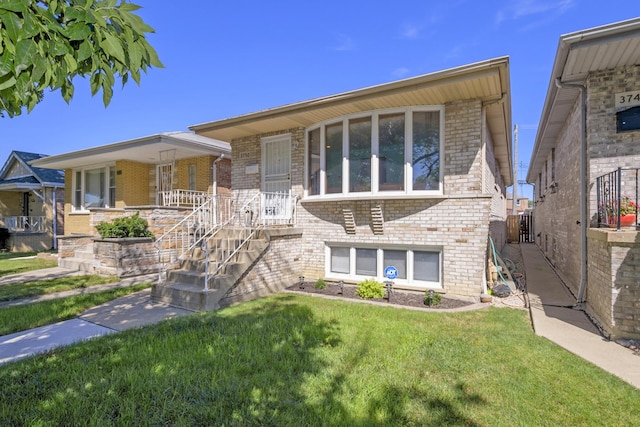 tri-level home with brick siding, a porch, and a front lawn