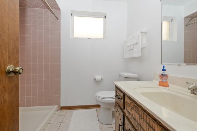 bathroom with tile patterned floors, tiled shower, toilet, and vanity