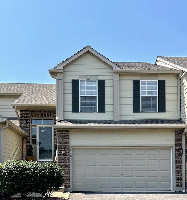 5203 Glenbrook Trl, Mchenry, IL 60050 - traditional home with an attached garage, brick siding, driveway, and a shingled roof