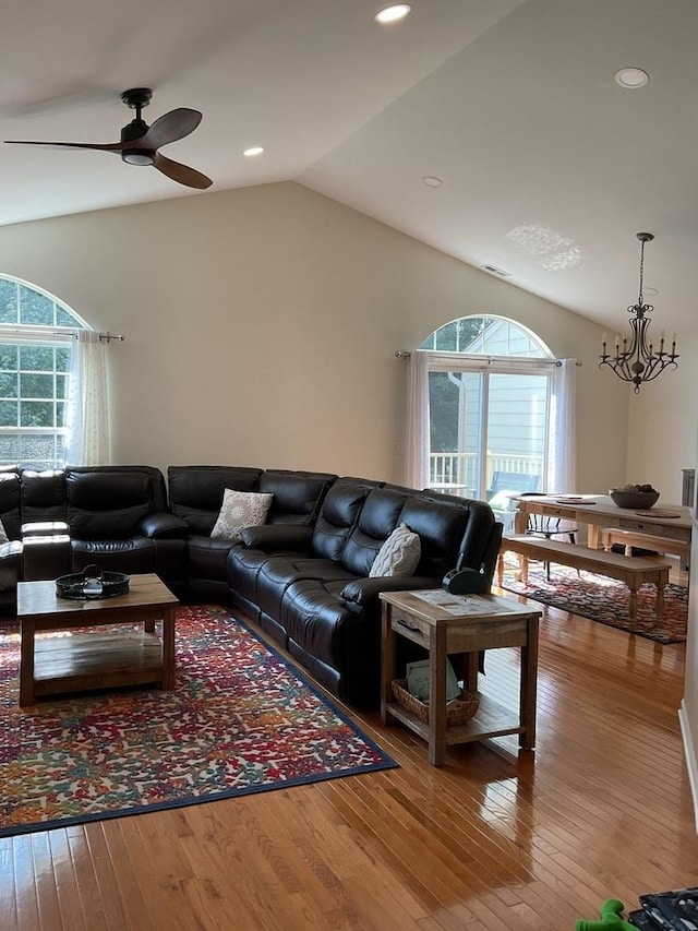5203 Glenbrook Trl, Mchenry, IL 60050 - living area featuring healthy amount of natural light, hardwood / wood-style floors, a ceiling fan, lofted ceiling, and a chandelier