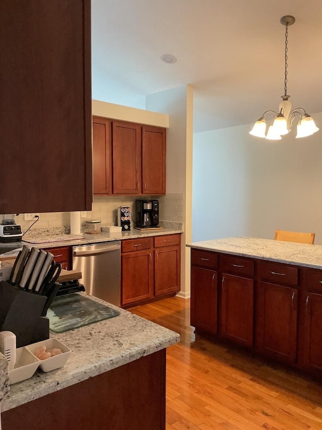 5203 Glenbrook Trl, Mchenry, IL 60050 - kitchen featuring stainless steel dishwasher, light wood-style floors, a chandelier, tasteful backsplash, and hanging light fixtures