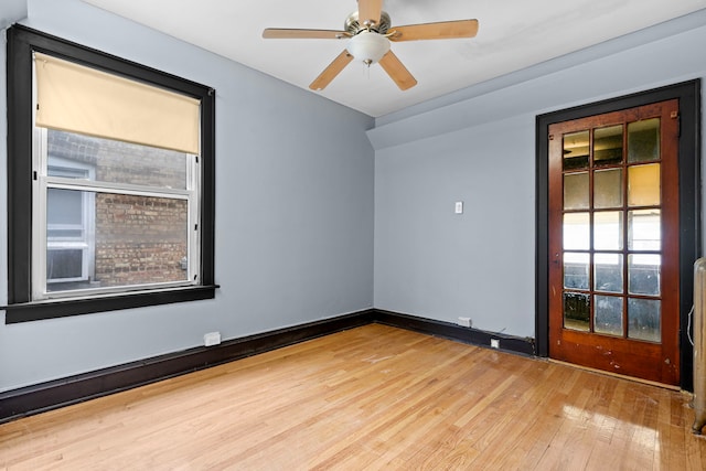 empty room with hardwood / wood-style floors and ceiling fan