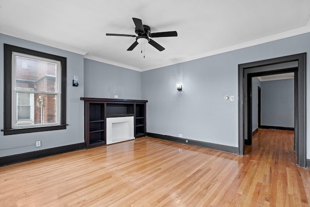 unfurnished living room with ceiling fan, crown molding, and light wood-type flooring