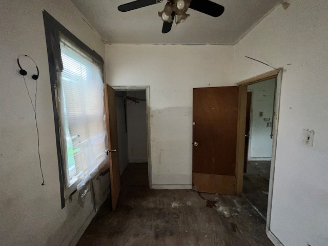 empty room featuring ceiling fan, dark hardwood / wood-style flooring, and a healthy amount of sunlight