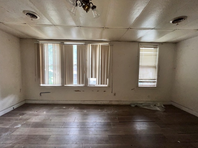 unfurnished room featuring a paneled ceiling and hardwood / wood-style floors