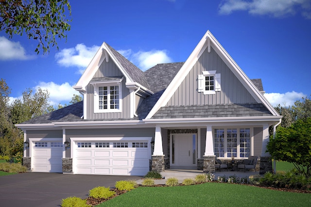 craftsman inspired home with a front yard and a garage