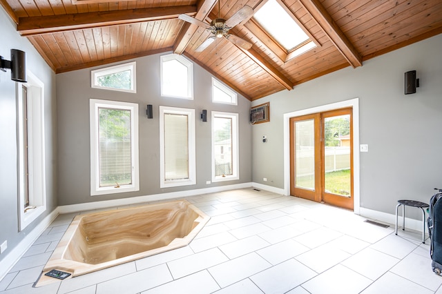 interior space with lofted ceiling with skylight, a wall mounted AC, wooden ceiling, and ceiling fan