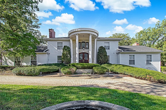 neoclassical / greek revival house with a front lawn