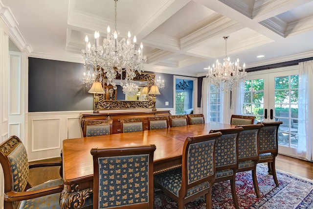 dining room featuring coffered ceiling, a healthy amount of sunlight, hardwood / wood-style floors, and a notable chandelier