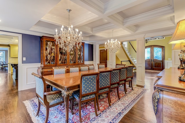 dining room with an inviting chandelier, ornamental molding, coffered ceiling, and wood-type flooring