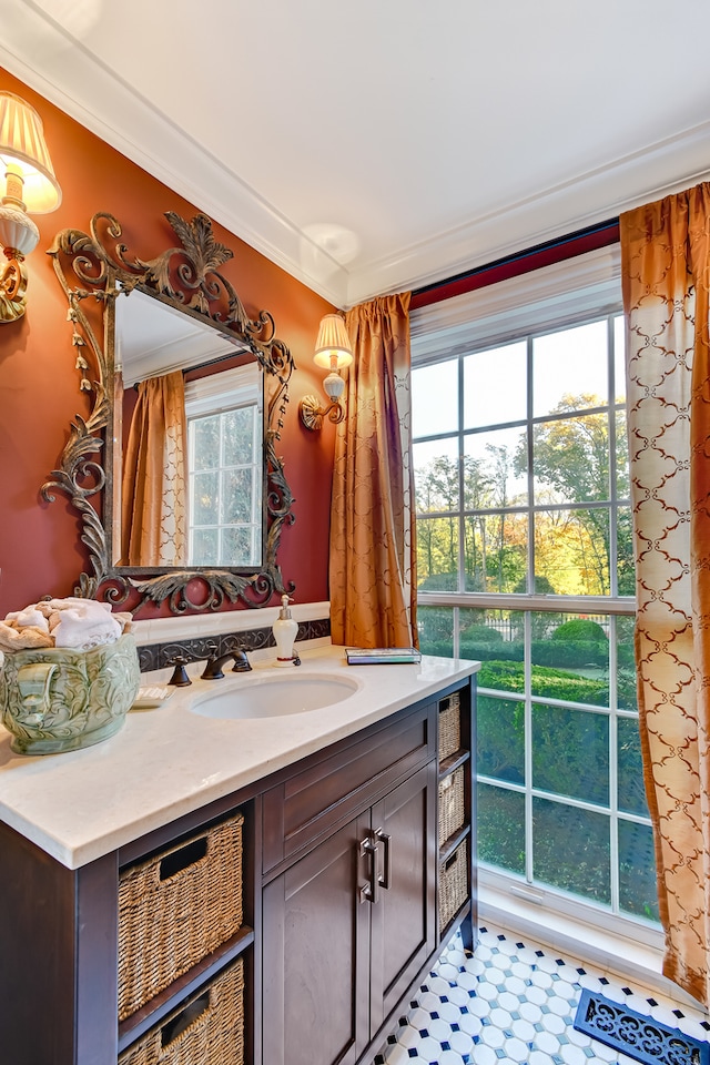 bathroom featuring tile floors, large vanity, and ornamental molding