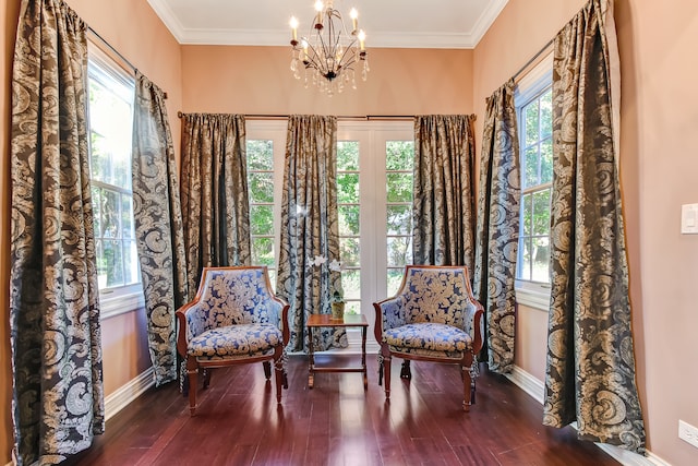 living area featuring dark hardwood / wood-style flooring, plenty of natural light, and a chandelier