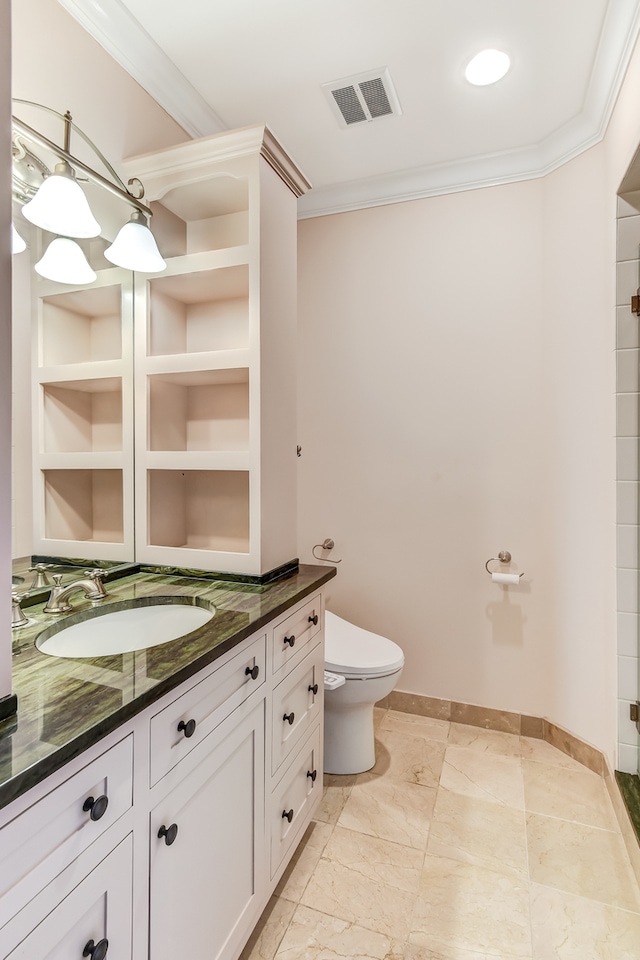 bathroom with toilet, ornamental molding, built in features, tile floors, and vanity