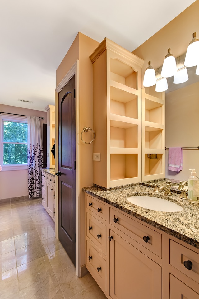 bathroom with large vanity and tile floors