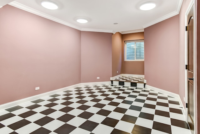 unfurnished room featuring ornamental molding and dark tile floors